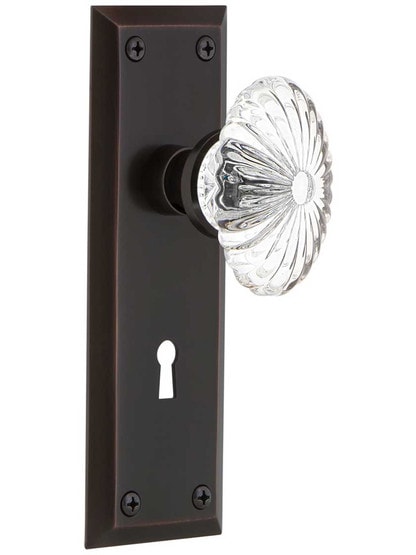 New York Style Door Set with Oval Fluted Crystal Glass Knobs in Timeless Bronze.